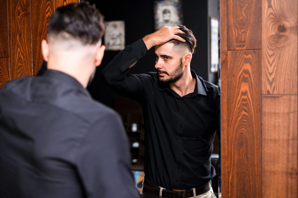 Man checking his new haircut barberia cerca de mi haircut services in Sugar Creek