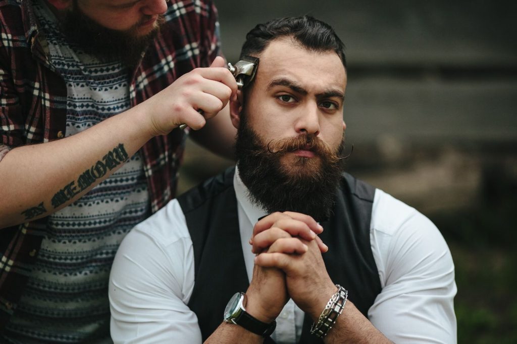 A man sitting on a barbershop waiting having his haircut in Stafford.