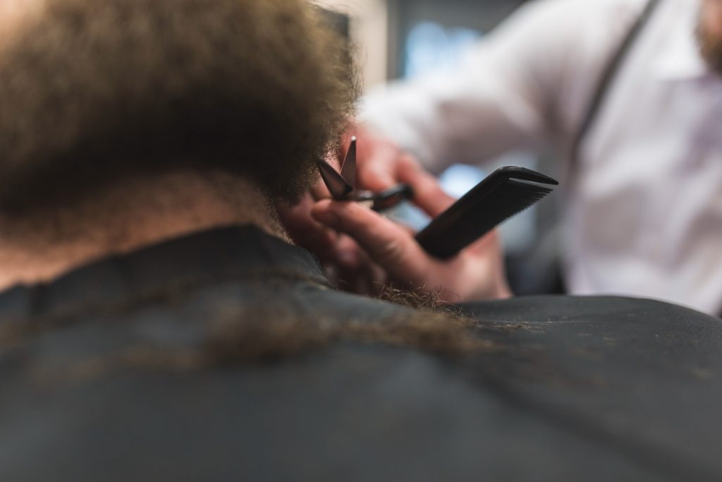 An image of a man getting his mens cutting beard at a barbershop in Perez.