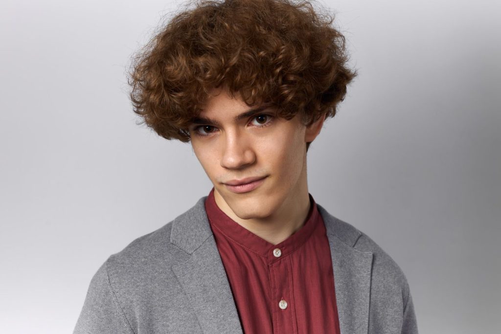 A man wearing a stylish toupee with a natural look, showcasing the mens toupee Colony Lake Estates design.