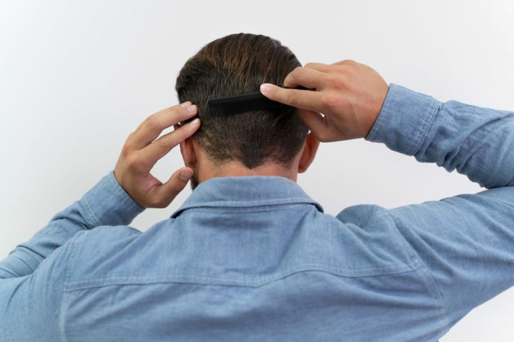Back of a man combing his mens toupee Stafford premium.