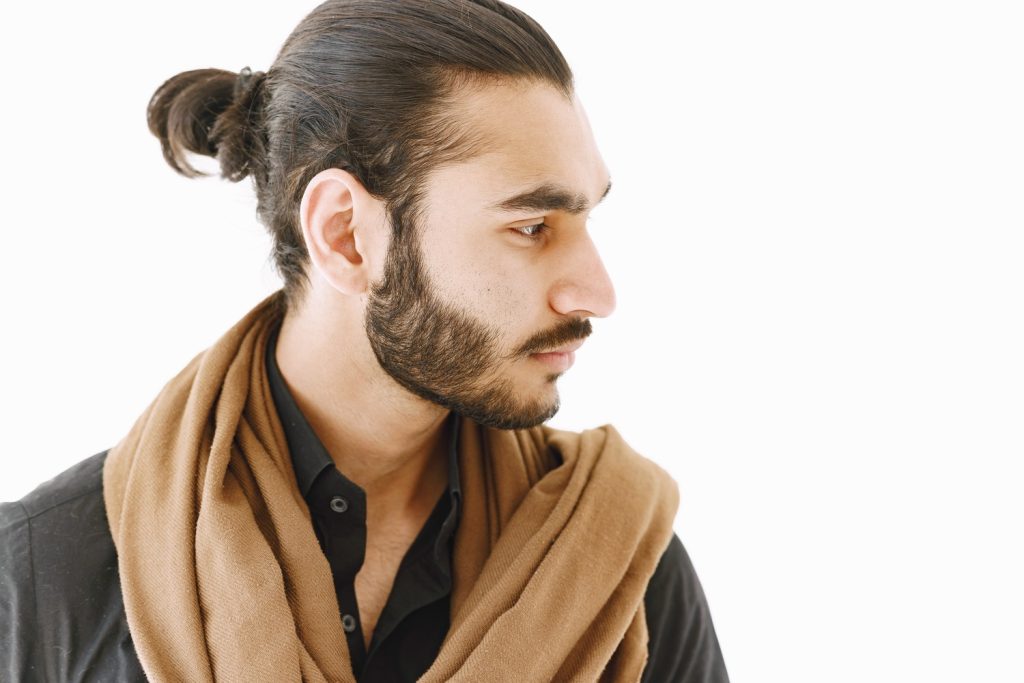 An image that portrays a fashionable man with a fresh, on-trend haircut in mens wig Stafford.