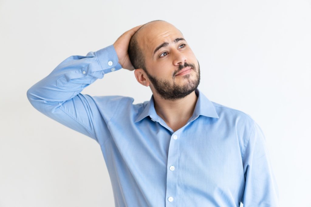 A man thinking about getting a number one mens hair replacement system in Stafford