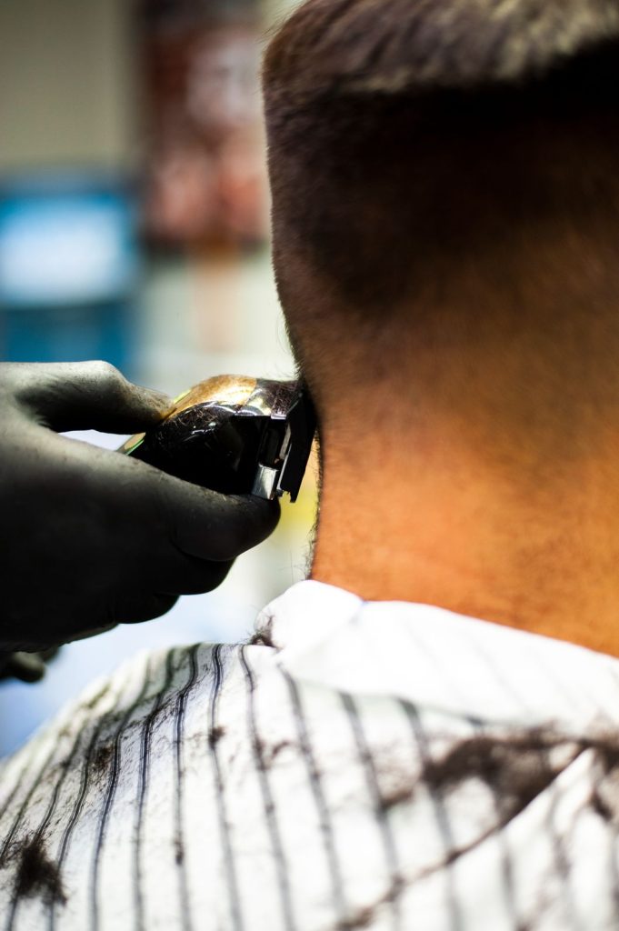 Man getting his hair shaved at walk in barber shops near The Fountains