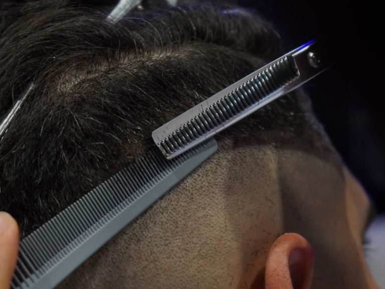 Professional barber shop stafford team styling hair with precision in a modern, welcoming barbershop.
