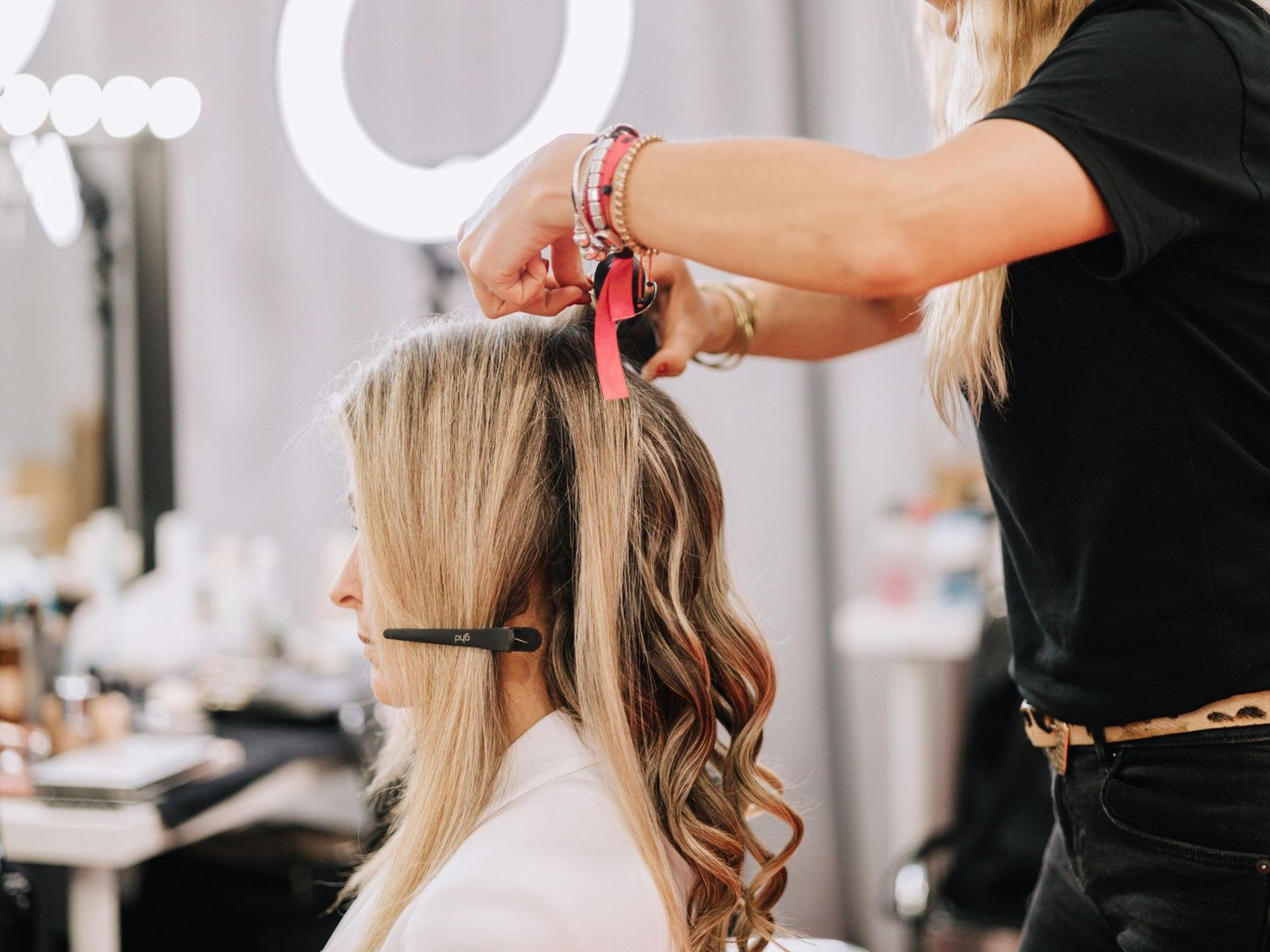 Skilled barber at barber shop Stafford crafting a precise haircut in a modern, vibrant barbershop setting.