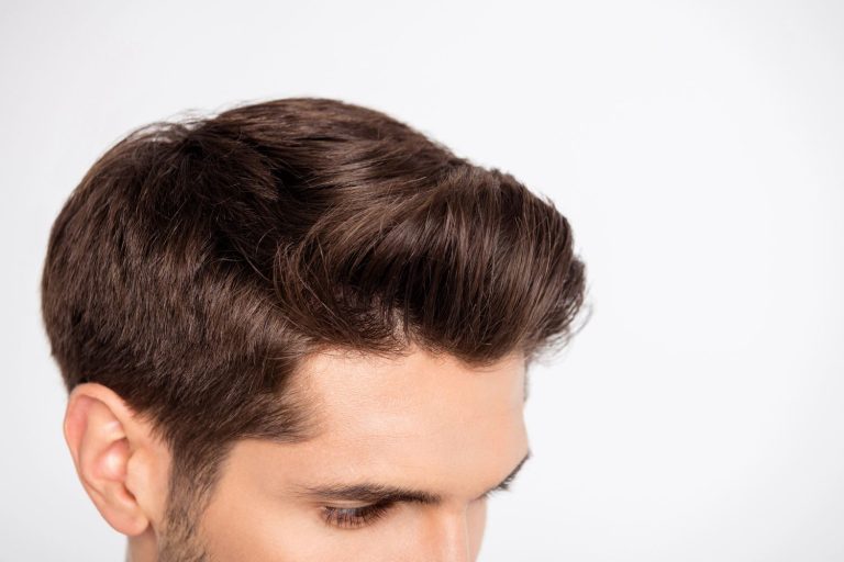 Close-up of a stylish men's toupee in Stafford, showcasing a natural brown hairpiece on a man.