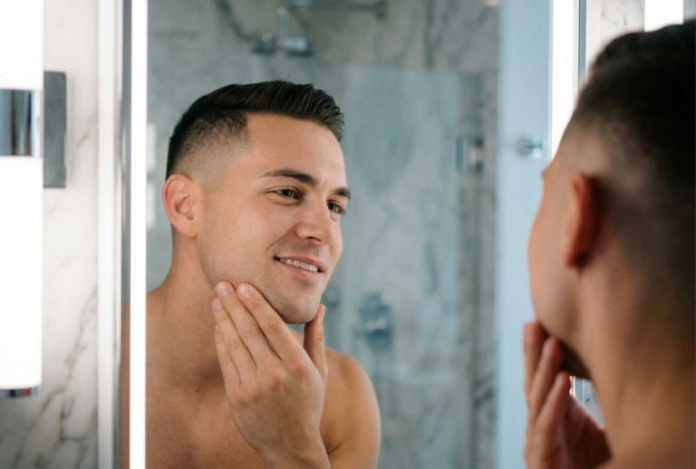 Man admiring smooth skin after professional mens waxing – clean jawline and cheeks
